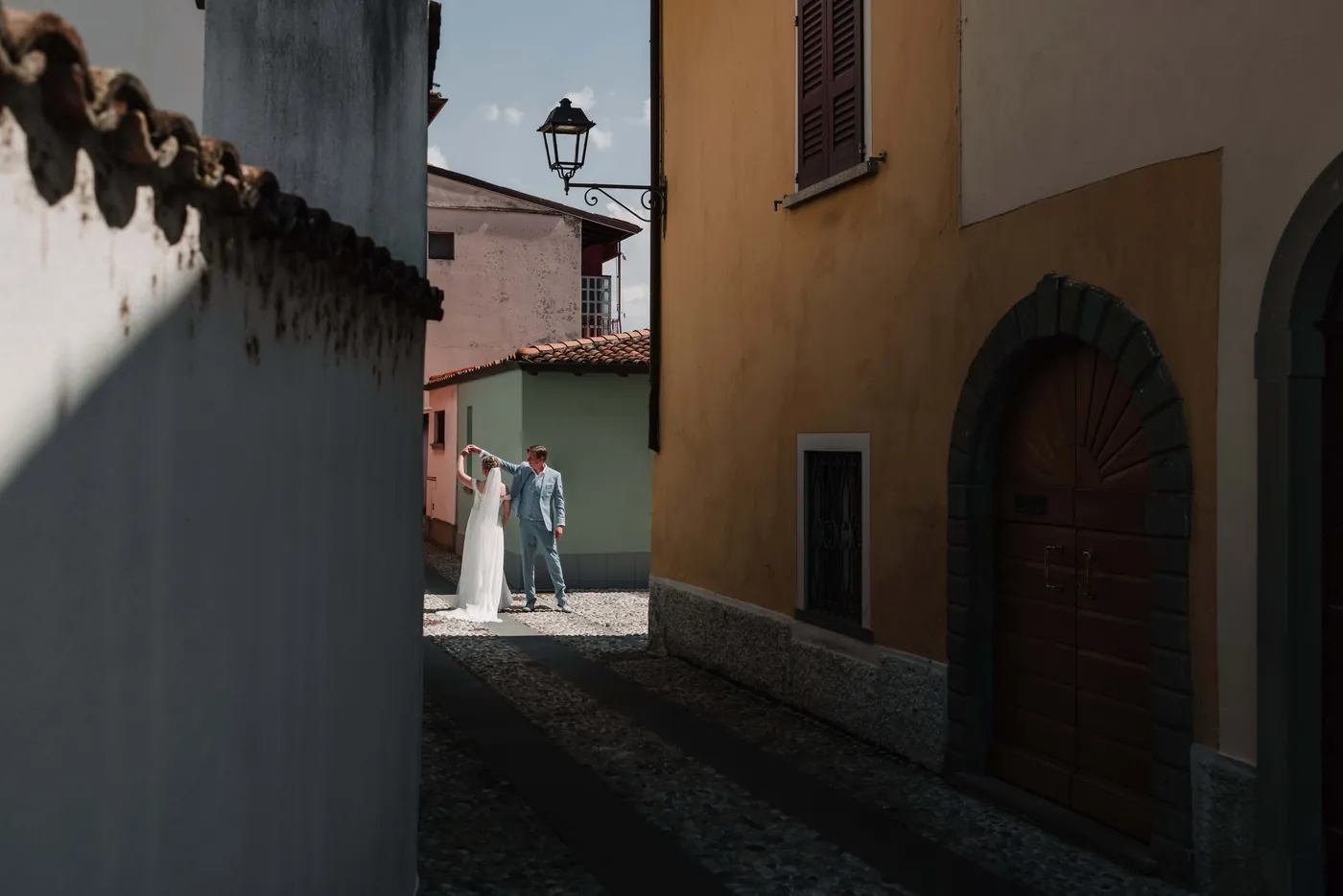 Bride and groom dancing in a warmly lit Italian street
